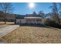 House exterior showcasing front porch and yard at 165 Nandover Way, Fayetteville, GA 30215
