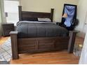 Spacious bedroom with hardwood floors and large bed at 190 Oakwood Lakes Dr, Hampton, GA 30228