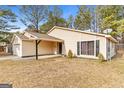 Charming single-story home with a well-maintained lawn and attached two-car garage at 210 Imad Ct, Fairburn, GA 30213