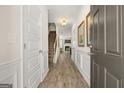Bright entryway with hardwood floors, leading to staircase and living area at 10462 Trellis Lane (Lot 41), Hampton, GA 30228