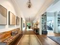 Long hallway featuring hardwood floors and artwork at 500 Augusta Ln, Chattahoochee Hills, GA 30268