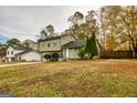 Green two-story house with a spacious yard and a fenced area at 2994 Meadow Wood Ct, Lawrenceville, GA 30044