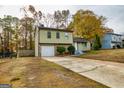Two-story house with an attached garage and a stone accent wall at 2994 Meadow Wood Ct, Lawrenceville, GA 30044
