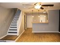Living room with hardwood floors, stairs, and a breakfast bar at 316 Quincy Ave, Mcdonough, GA 30253