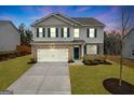 Two-story house with gray siding, brick accents, and a two-car garage at 6817 Chataran Dr, Lithia Springs, GA 30122