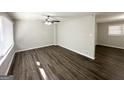 Spacious living room with dark laminate floors and lots of natural light at 4785 Kent Rd, Atlanta, GA 30337