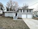 Newly painted gray brick ranch house with a 2-car garage at 2318 Emerald Falls Dr, Decatur, GA 30035