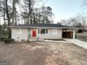 Newly renovated brick ranch house with red door and carport at 4303 Mercer Rd, Decatur, GA 30035