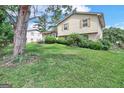 Two-story house with brick and siding, a sloping lawn, and large tree at 214 W Windemere Way, Jonesboro, GA 30238