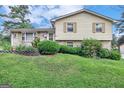 Two-story house with brick and siding, a sloping lawn, and a driveway at 214 W Windemere Way, Jonesboro, GA 30238