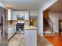 Modern kitchen with island and stainless steel appliances at 3031 Golden Dr, East Point, GA 30344