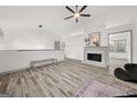 Living room with fireplace, hardwood floors, and modern chandelier at 2668 Laurel Woods Se Ln, Conyers, GA 30094