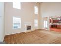 Spacious living room with a fireplace and view into the kitchen at 5539 Halsey Trce, Atlanta, GA 30349