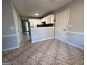 Kitchen features white cabinets, tile floors, and a breakfast bar at 3203 Pawnee Dr, Rex, GA 30273