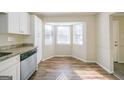 Eat-in kitchen featuring stainless steel dishwasher, granite countertops, and bright windows at 1129 Winston Dr, Decatur, GA 30032