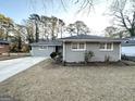 Newly painted gray ranch home with a spacious lawn at 1884 Derrill Dr, Decatur, GA 30032