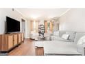 Bright living room features hardwood floors, plush seating, and ample natural light at 12 Independence Nw Pl # 12, Atlanta, GA 30318