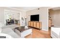 Open-concept living room flows into the dining area with hardwood floors and natural light at 12 Independence Nw Pl # 12, Atlanta, GA 30318