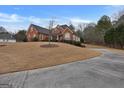 Brick house with a long driveway and grassy yard at 55 Clearbrook Ct, Covington, GA 30016