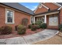 Welcoming front entrance with a brick walkway and landscaping at 55 Clearbrook Ct, Covington, GA 30016