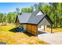 Inviting modern farmhouse with a covered patio, open carport, and gravel driveway at 90 Ayers Rd, Bowdon, GA 30108