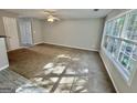 Spacious living room featuring carpet and large windows at 1030 Chase Ln, Mcdonough, GA 30253