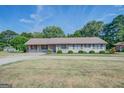 Single story home with a well-manicured lawn at 463 Conyers Rd, Mcdonough, GA 30253