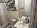 Functional bathroom featuring a standard toilet, sink, and shower-tub combination at 20 Sw Pine Canyon Sw Dr, Atlanta, GA 30331