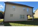Rear view of house showcasing additional windows and patio at 385 Mcgiboney Ln, Covington, GA 30016