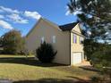 Tan house with a side view of garage and large backyard at 385 Mcgiboney Ln, Covington, GA 30016