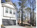 View of the home's garage and side elevation, showcasing its architectural style at 5706 Rockfern Dr, Lilburn, GA 30047