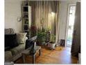 Living room with hardwood floors and lots of plants at 3798 Adkins Nw Rd, Atlanta, GA 30331