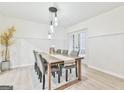 Bright dining room with wood table and six chairs at 4083 Audubon Dr, Marietta, GA 30068