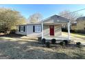 Charming brick ranch house featuring a covered porch and mature landscaping at 1876 Flat Shoals Se Rd, Atlanta, GA 30316