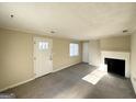 Spacious living area featuring a fireplace, hardwood floors, and neutral walls at 1876 Flat Shoals Se Rd, Atlanta, GA 30316