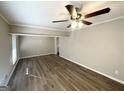 Spacious living room featuring hardwood floors and ceiling fan at 3721 W Potomac Dr, East Point, GA 30344