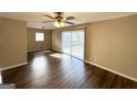 Bright living room featuring hardwood floors and sliding glass doors at 2729 Pinella Sw Dr, Atlanta, GA 30331
