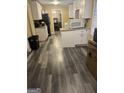 Galley kitchen with white cabinets and grey flooring at 1708 S Deshon Rd, Lithonia, GA 30058