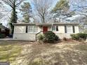 Charming ranch home with red front door and well-manicured lawn at 306 Ard Nw Pl, Atlanta, GA 30331
