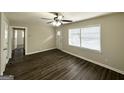 Spacious living room featuring hardwood floors and updated door at 306 Ard Nw Pl, Atlanta, GA 30331