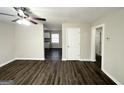 Bright living room with dark laminate flooring and view to kitchen at 306 Ard Nw Pl, Atlanta, GA 30331