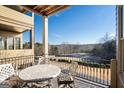 Covered porch with table and chairs overlooking a golf course at 3156 Neal Ct, Cumming, GA 30041