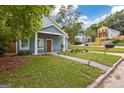 Charming blue home with a manicured lawn and inviting front walkway at 1302 Ladd St, Atlanta, GA 30310