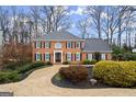 Two-story house with circular driveway and mature trees at 3509 Billingsley Dr, Marietta, GA 30062