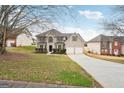 Two-story house with driveway, landscaping, and a two-car garage at 9507 Byrom Rd, Jonesboro, GA 30236