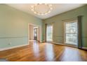 Light-filled dining room with hardwood floors, built-ins, and a chandelier at 960 Todd Dr, Covington, GA 30014