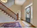 Two-story entryway with hardwood floors, wooden staircase, and a view of the living room at 960 Todd Dr, Covington, GA 30014