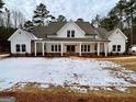 Two-story farmhouse with white siding, covered porch, and landscaping at 4619 Parkwood Rd, Social Circle, GA 30025