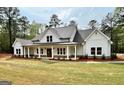 Charming home with a covered front porch, showcasing a blend of modern design and country charm at 4619 Parkwood Rd, Social Circle, GA 30025