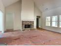 Spacious living room with brick fireplace and high ceilings at 4619 Parkwood Rd, Social Circle, GA 30025